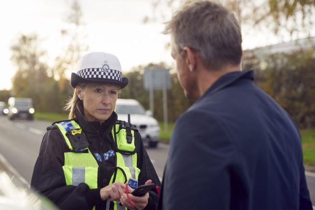 getting past the gatekeeper in B2B telemarketing highlighted by traffic officer stopping businessman