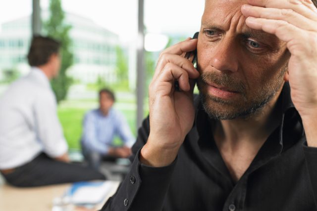 business man on phone annoyed by jargon and buzzwords senior executives hate