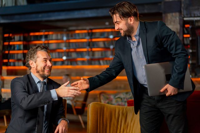 Two businessmen shaking hands after choosing the right marketing agency