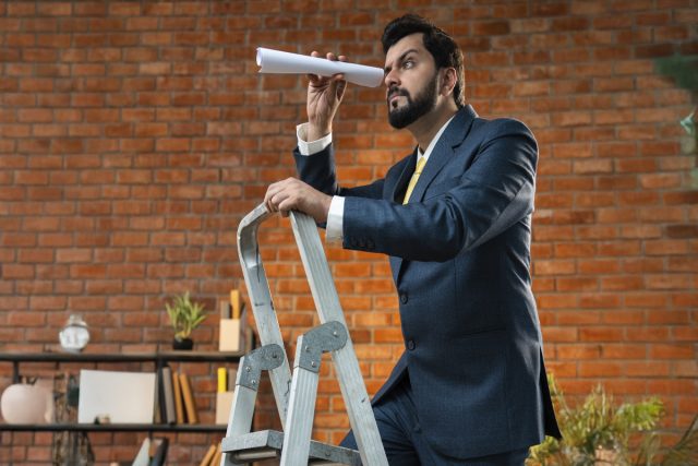 business man standing on ladder to display B2B relationship ladder