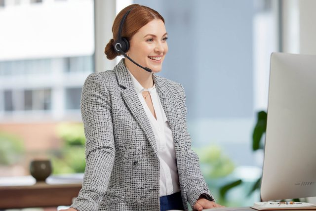 Mood music in sales calls – confident caller standing and speaking with a relaxed, open tone