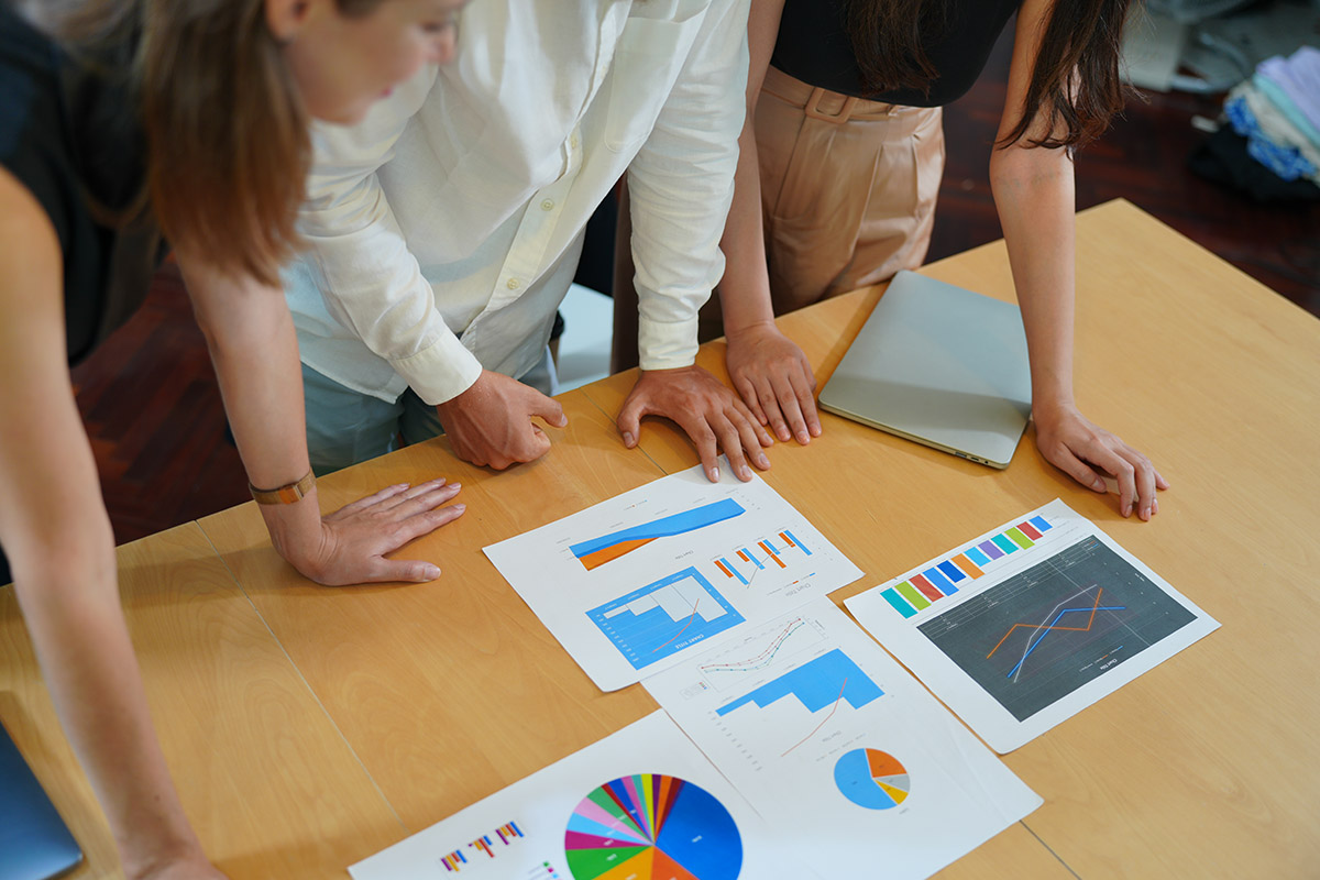 Team around table review facts and data on voice of customer VoC